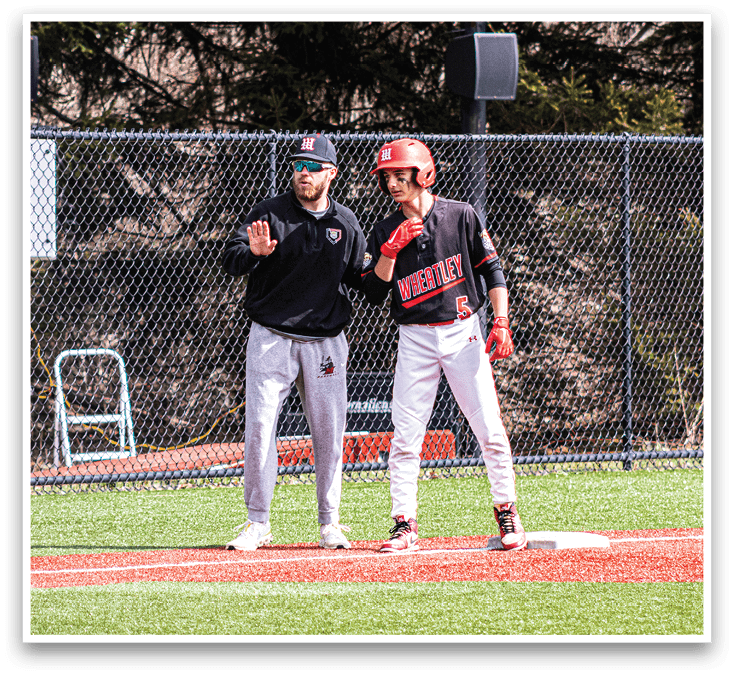 Two men standing on a baseball field. Description generated by AI