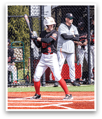 A baseball player is holding a bat and getting ready to hit the ball. Description generated by AI