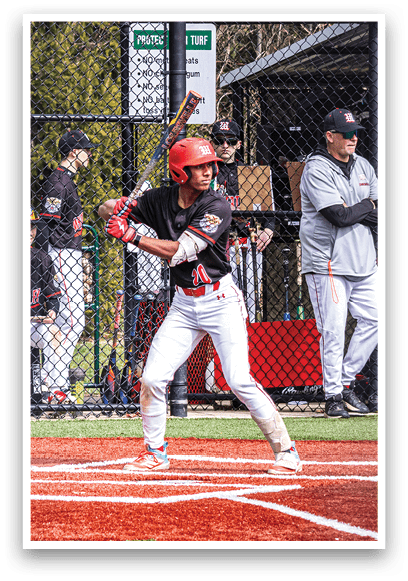 A baseball player is holding a bat and getting ready to hit the ball. Description generated by AI