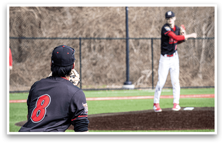 A baseball player in a black jersey is throwing a ball. Description generated by AI