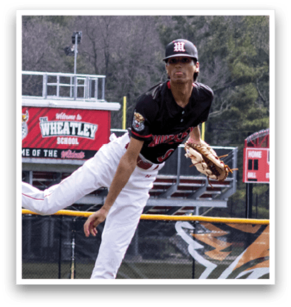 A baseball player in a black and red uniform is pitching a ball. Description generated by AI