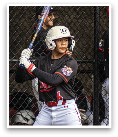 A baseball player holding a bat. Description generated by AI