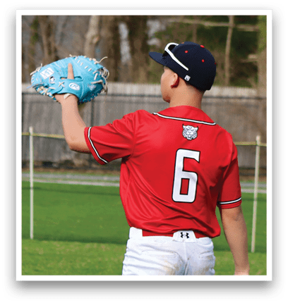 A baseball player wearing a red shirt and white pants holding a blue baseball glove. Description generated by AI