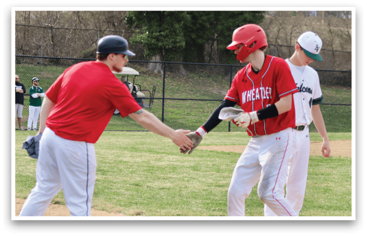 A baseball player in a red shirt shakes hands with another player. Description generated by AI