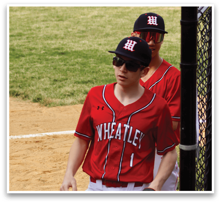 A baseball player wearing a red and black uniform. Description generated by AI
