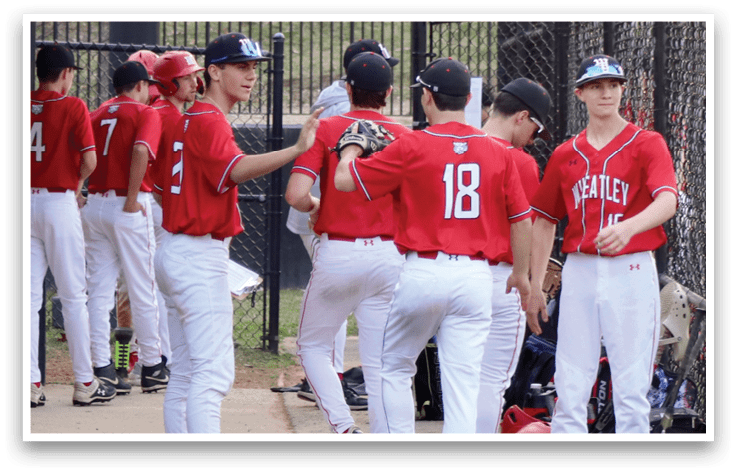 A group of baseball players standing on a field. Description generated by AI