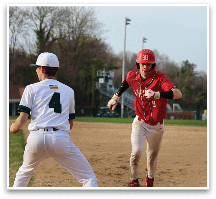 A baseball player wearing a red shirt and white pants running on the field. Description generated by AI