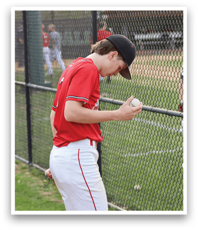 A baseball player wearing a red shirt and white pants. Description generated by AI