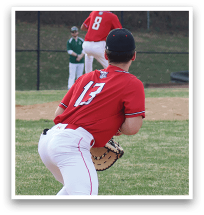 A baseball player in a red shirt and white pants is getting ready to throw the ball. Description generated by AI