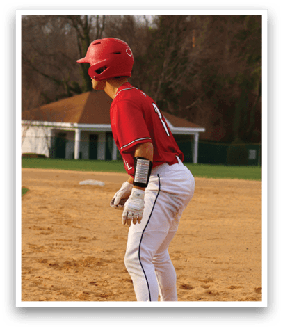 A baseball player wearing a red shirt and white pants. Description generated by AI