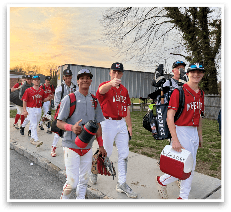 A group of baseball players walking down a sidewalk. Description generated by AI