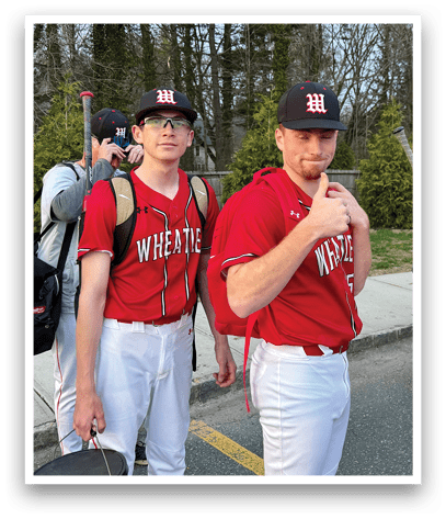 Two men wearing red and white shirts. Description generated by AI