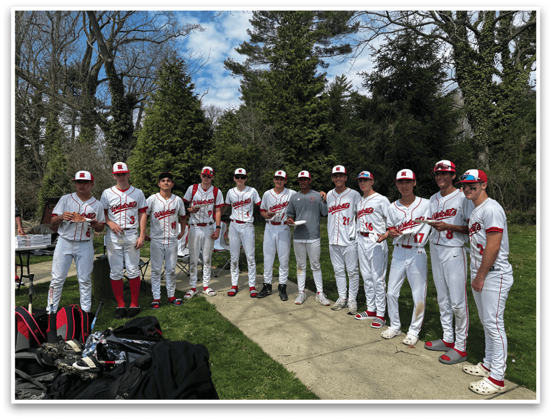 A baseball player wearing a red shirt and red helmet. Description generated by AI