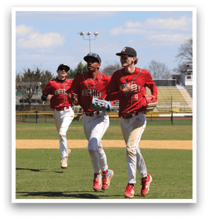 A baseball player in a red shirt and white pants is getting ready to throw the ball. Description generated by AI