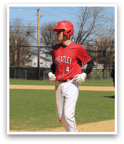 A baseball player wearing a red shirt and white pants. Description generated by AI