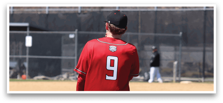 A baseball player wearing a red shirt and white pants is holding a blue baseball glove. Description generated by AI