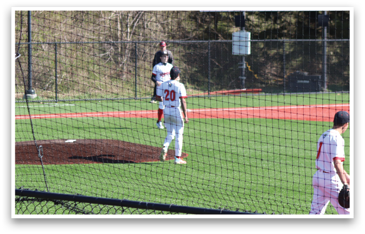 A baseball field with a scoreboard and a fence. Description generated by AI