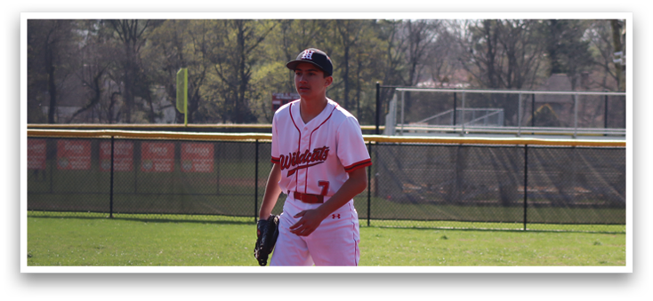 A baseball player wearing a red and white uniform. Description generated by AI