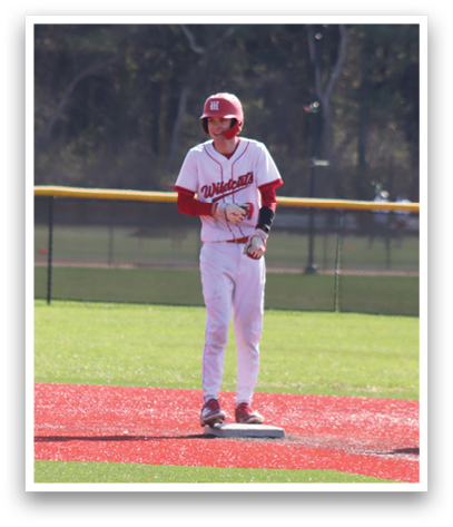 A baseball player is standing on the field with a bat. Description generated by AI