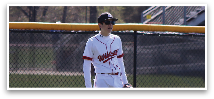 A baseball player standing on a field. Description generated by AI
