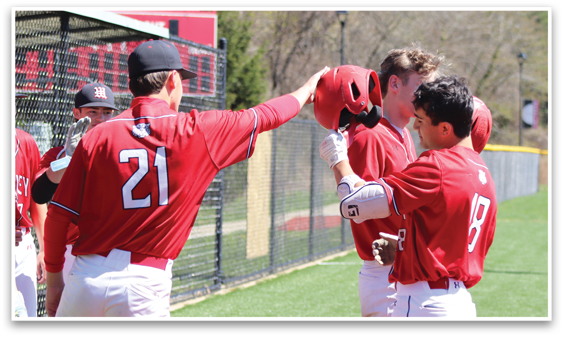 A group of baseball players wearing red shirts and red hats. Description generated by AI