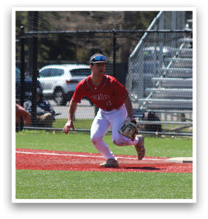 A baseball player in a red shirt and white pants is catching a ball. Description generated by AI