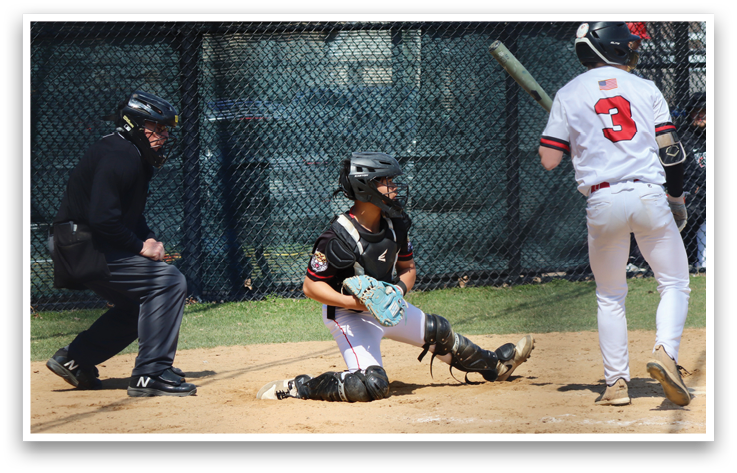 A baseball player is holding a bat, ready to swing. Description generated by AI