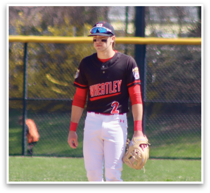A baseball player wearing a black and red jersey. Description generated by AI