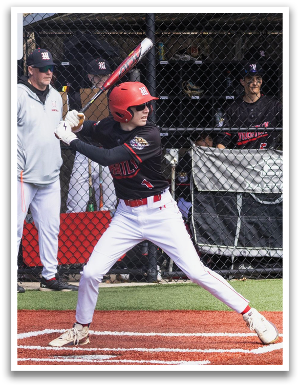 A baseball player in a black and red jersey is swinging a bat. Description generated by AI