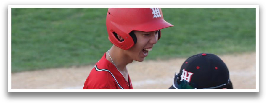 A baseball player wearing a red helmet and a red jersey. Description generated by AI