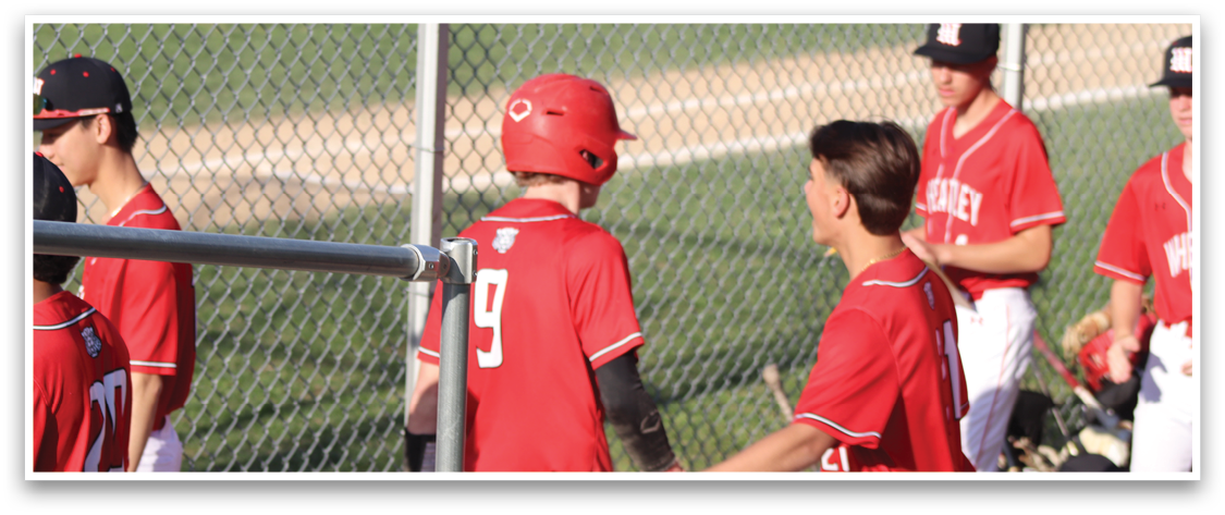 A group of baseball players wearing red and white uniforms. Description generated by AI