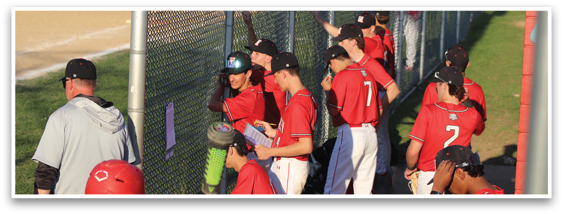 A group of baseball players sitting on a bench. Description generated by AI
