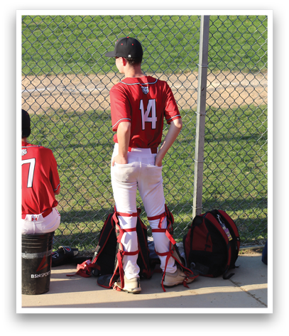 A baseball player wearing a red shirt with the number 17 on it. Description generated by AI