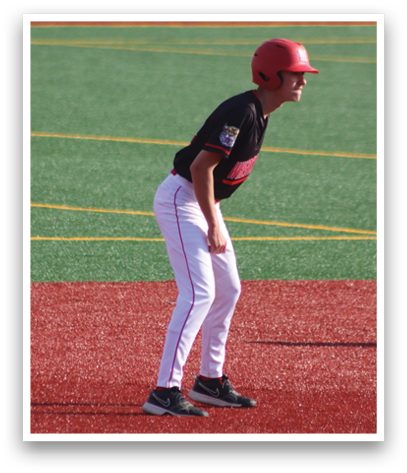 A baseball player bending over on a field. Description generated by AI