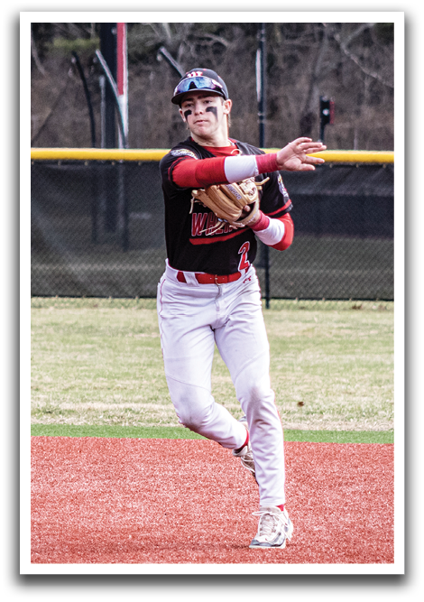 A baseball player in a black and red uniform is throwing a ball. Description generated by AI