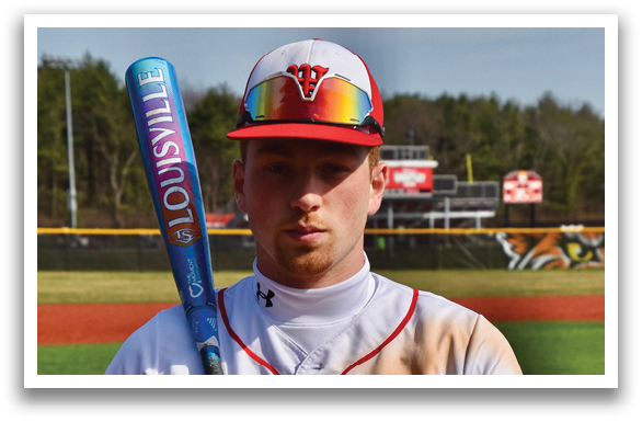 A baseball player holding a bat. Description generated by AI