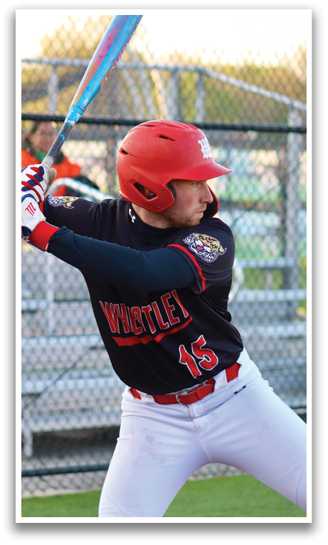 A baseball player in a black and red uniform is swinging a bat. Description generated by AI
