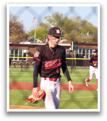 A baseball player wearing a black and red shirt and white pants. Description generated by AI