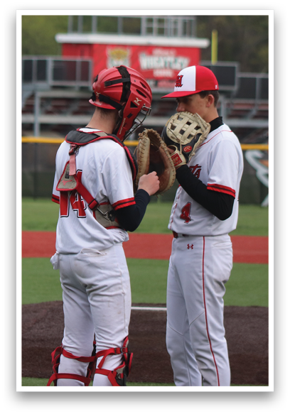 Two baseball players on a field. Description generated by AI