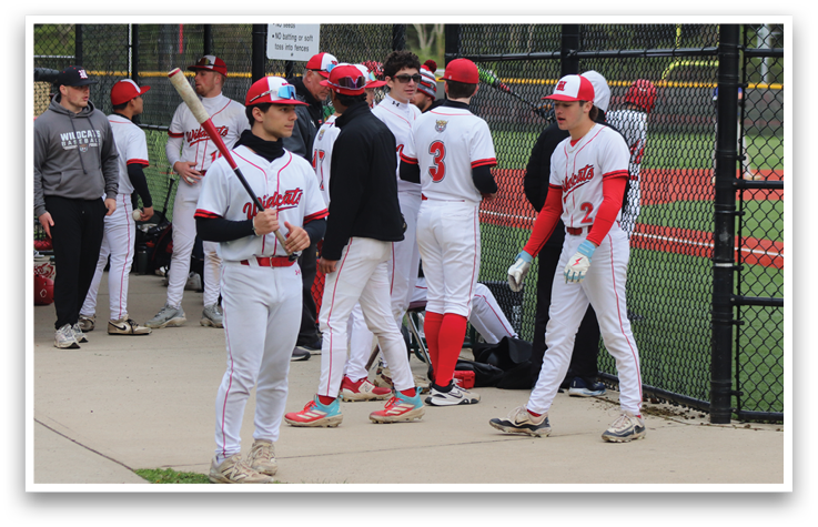 Baseball players standing on a field. Description generated by AI