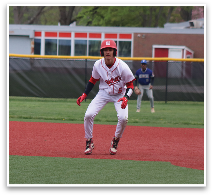 A baseball player in a red and white uniform is running to first base. Description generated by AI