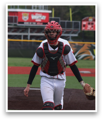 A baseball player in a white uniform and red helmet. Description generated by AI