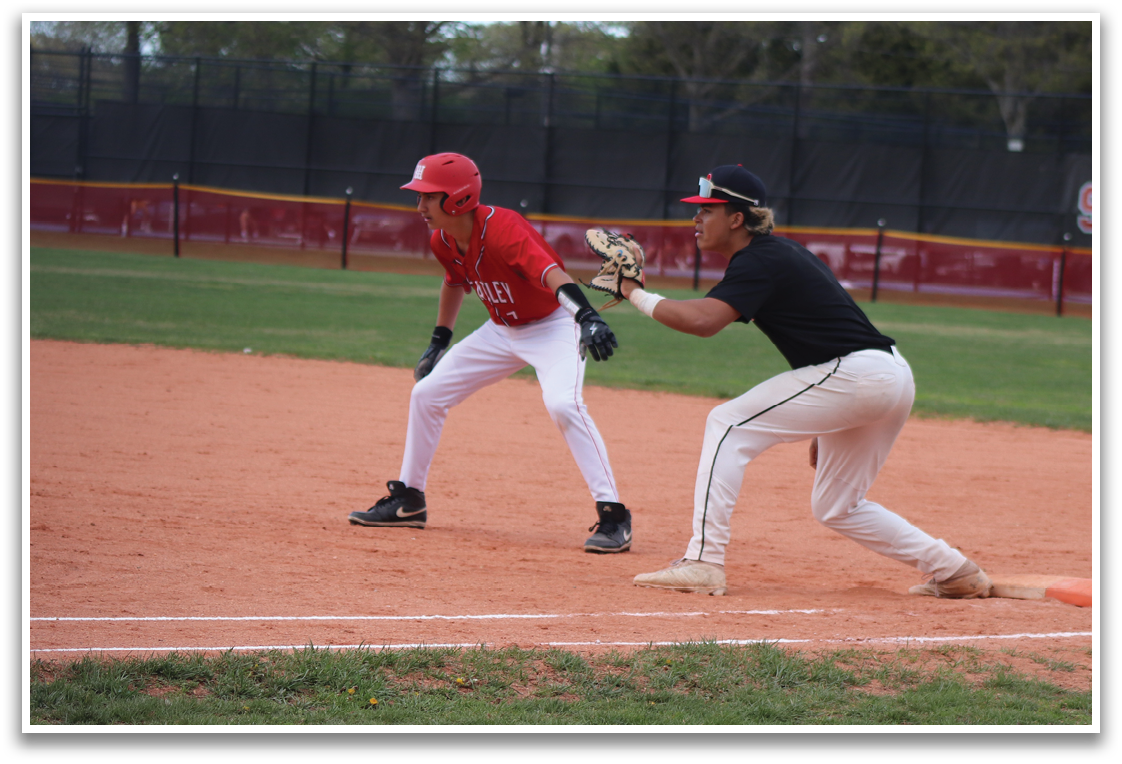 A baseball player wearing a red shirt and white pants is running towards a base. Description generated by AI