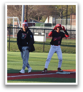 A baseball player wearing a black and red jersey. Description generated by AI