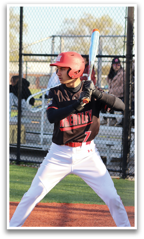 A baseball player in a black and red uniform is swinging a bat. Description generated by AI