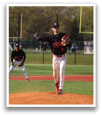 A baseball player in a black and red jersey is pitching a ball. Description generated by AI