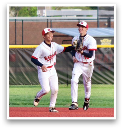 A baseball player in a white and red uniform is pitching a ball. Description generated by AI