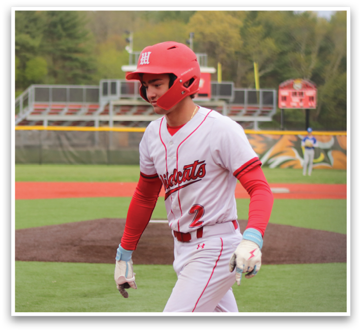 A baseball player in a red and white uniform is running to first base. Description generated by AI