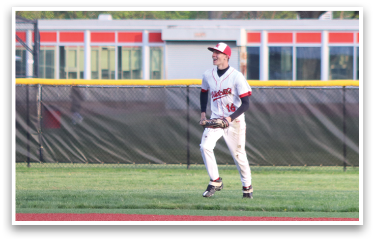 Baseball players standing on a field. Description generated by AI