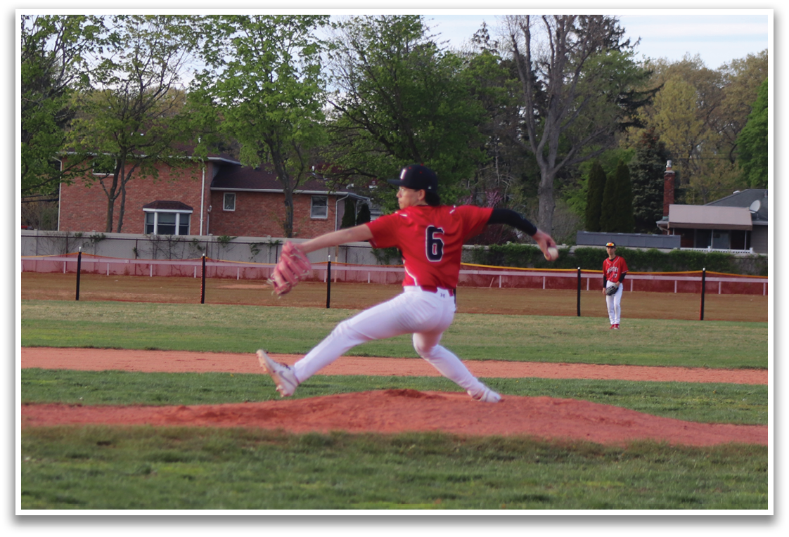 A baseball player wearing a red shirt and white pants is running towards a base. Description generated by AI
